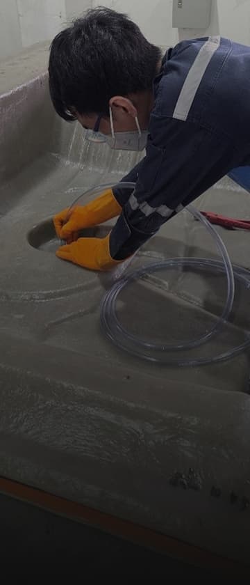 Worker using digital cutter on green material